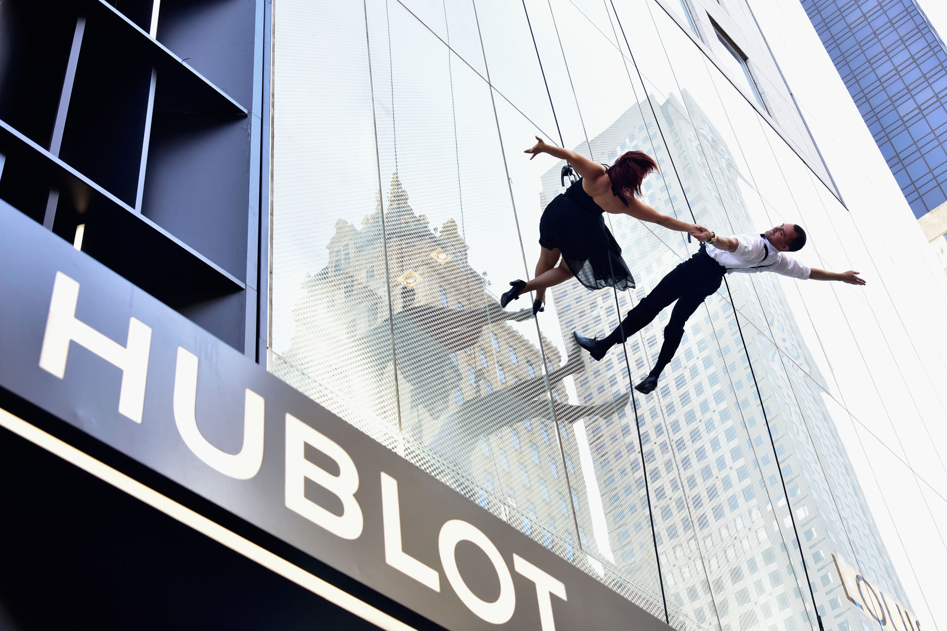 Dancers rappel down the facade of the Hublot Fifth Avenue Boutique