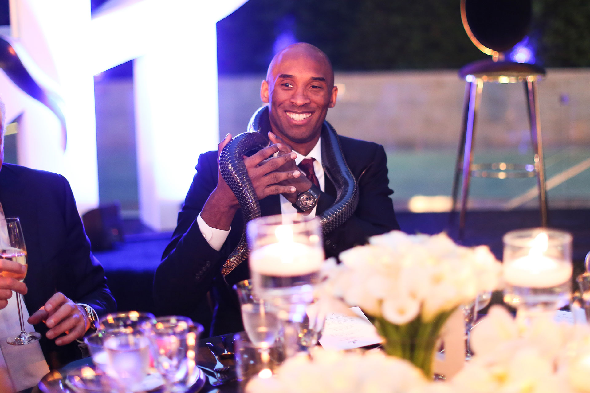 Kobe Bryant holds a snake at the Hublot HeroVillain Launch